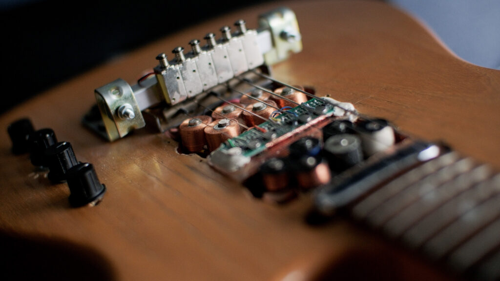 The guitar body. The electrics under the strings are exposed showing Craig's modifications.